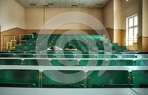 Two tired students sleep in the classroom at the Desk. it is difficult to study at University