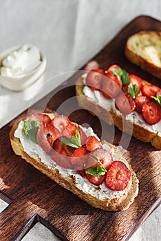 Two toasts or bruschetta with strawberry and cream cheese