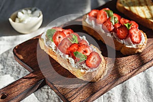 Two toasts or bruschetta with strawberry and cream cheese