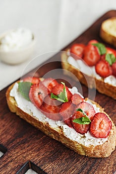 Two toasts or bruschetta with strawberry and cream cheese