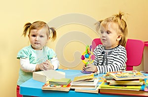 Two toddler girls playing