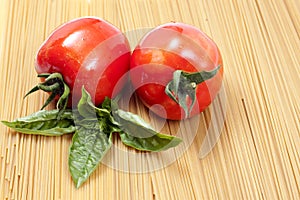Two tomatoes and basil
