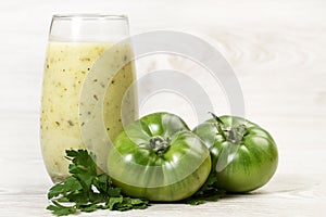 Two tomatoes, parsley and a healthy drink