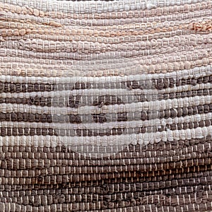 Two tone brown and beige Greek traditional kurelou hand wooven carpet top view close up.