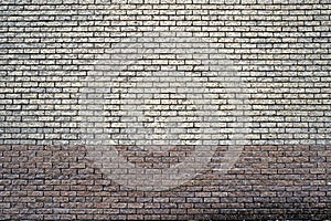 Two-tone gray-brown wall texture made of small bricks. A discreet background. A place for a label