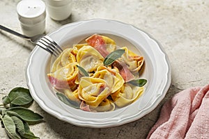 Two-tonned stuffed italian pasta, beetroot colored. Tortelloni with ricotta and red radicchio filling