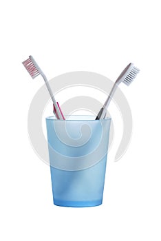 Two toothbrushes in a glass