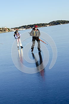 Two tour skaters on smoth ice