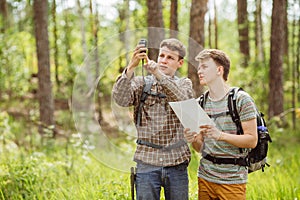 Two tourist determine the route map and navigator