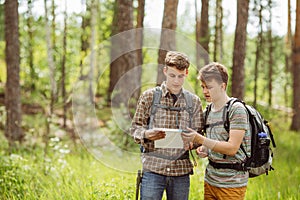 Two tourist determine the route map and navigator