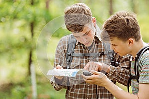 Two tourist determine the route map and navigator