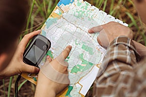 Two tourist determine the route map and navigator