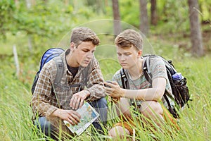 Two tourist determine the route map and navigator