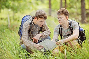 Two tourist determine the route map and navigator