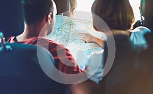 Two tourist traveler together hold in hands europe cartography, view and plan tourist way road, trip in transportation, couple hip