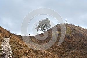 Two tourists climb the path to the top of the mountain.