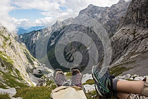 Two tourists enjoying wonderful breathtaking view of mountain peaks