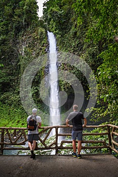 Two tourists looking at the La Fortuna Waterfall in Costa Rica