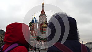 Two tourists are on red square in Moscow. The women admire the architecture of Russia.