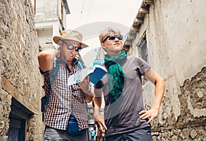 Two tourists try to navigate with guidebook on unknown asian street