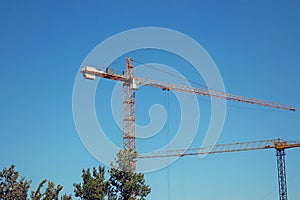 Two tower cranes at a construction site