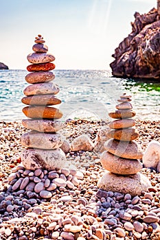 Two towers of flat stones on the beach. Stone balancing is the art discipline, or hobby in which rocks naturally balanced on top