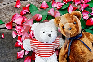 Two Toy bear doll have falling in love with Rose petals background .