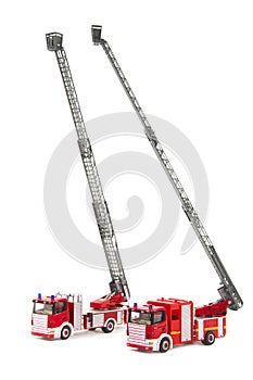 Two toy firetrucks wit ladders