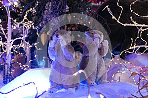 Two toy gophers on the background of an artificial forest and snow. Christmas and New Year concept