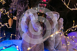 Two toy gophers on the background of an artificial forest and snow. Christmas and New Year concept