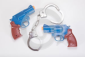 Two toy handguns with handcuffs and copy space