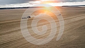 Two tractors plowing the field at sunrise . Agriculture view aerial photography
