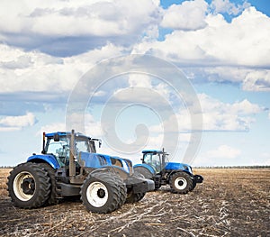 Two tractors work in the field