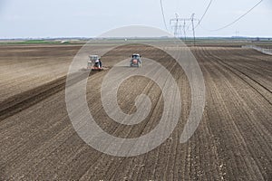 Two tractors are working in the field