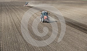 Two tractors are working in the field