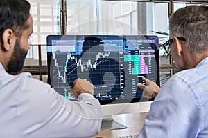 Two traders brokers stock exchange investors analyzing crypto trading charts.