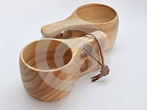 two traditional finnish wooden kuksa cups on white background