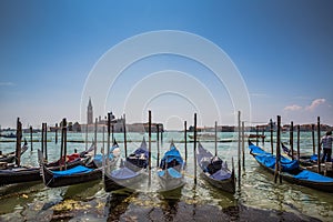 Grand Canal gondolas at pier, island of San Giorgio Maggiore in the background