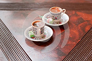 Two traditional porcelain turkish coffee cups with turkish delight