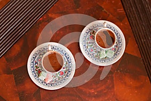 Two traditional porcelain turkish coffee cups with turkish delight