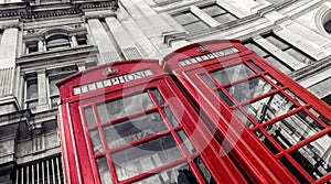 Two traditional red telephone booths in London city