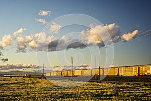 Two Trains Passing Each Other at Sunset