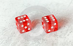 Two translucent red craps dices on white board showing Boxcars or Midnight double number 6