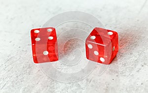 Two translucent red craps dices on white board showing Easy Six Jimmie Hicks umber 4 and 2 photo