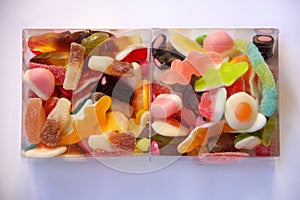 Two transparent boxes of multicolored jujubes