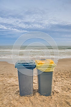 Two trash cans on the beach