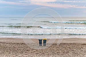 Two trash cans on the beach