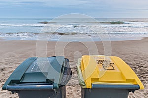 Two trash cans on the beach