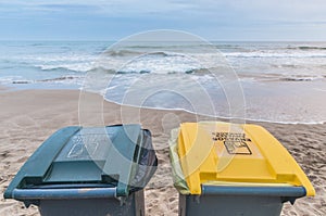 Two trash cans on the beach