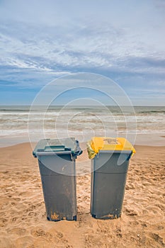 Two trash cans on the beach